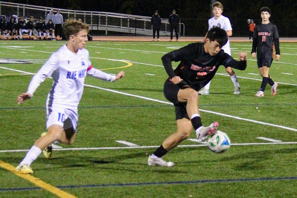 The Ridgefield boys soccer team in action against Darien during the 2025 season. - Photo courtesy of Helen Epley