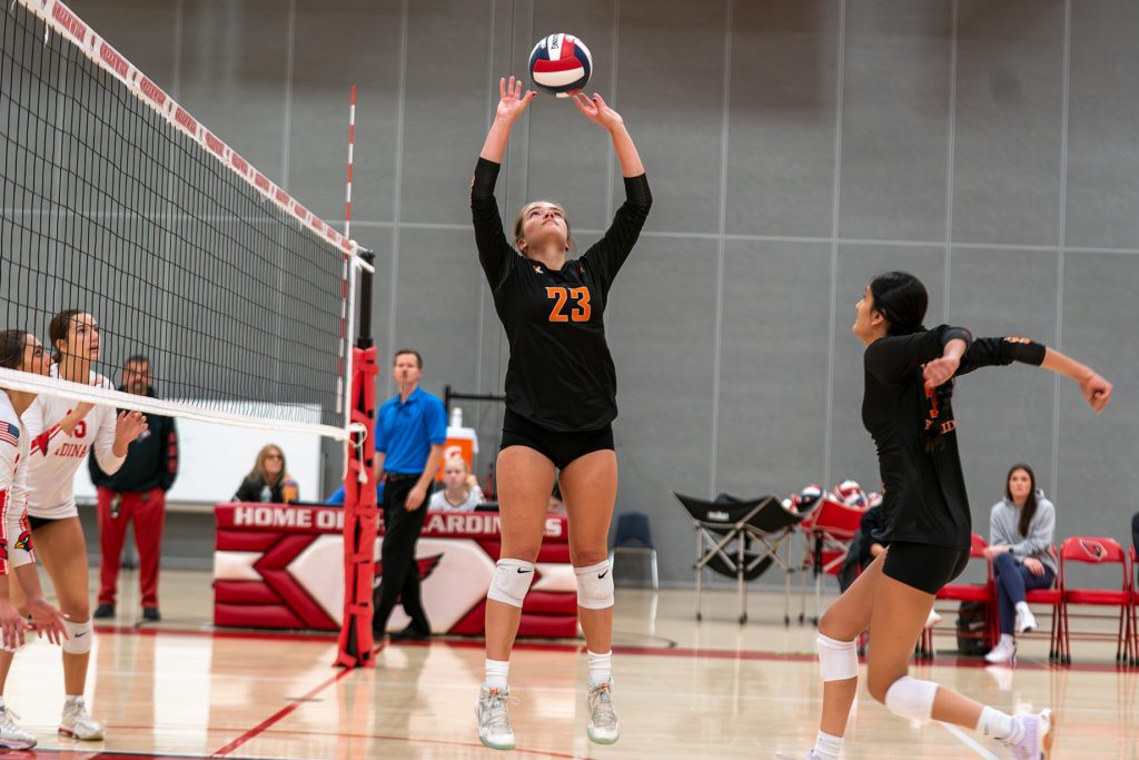 Ridgefield's Brenna Williams (23) sets the ball during a match against Greenwich. - Photo courtesy of Simon Mendez