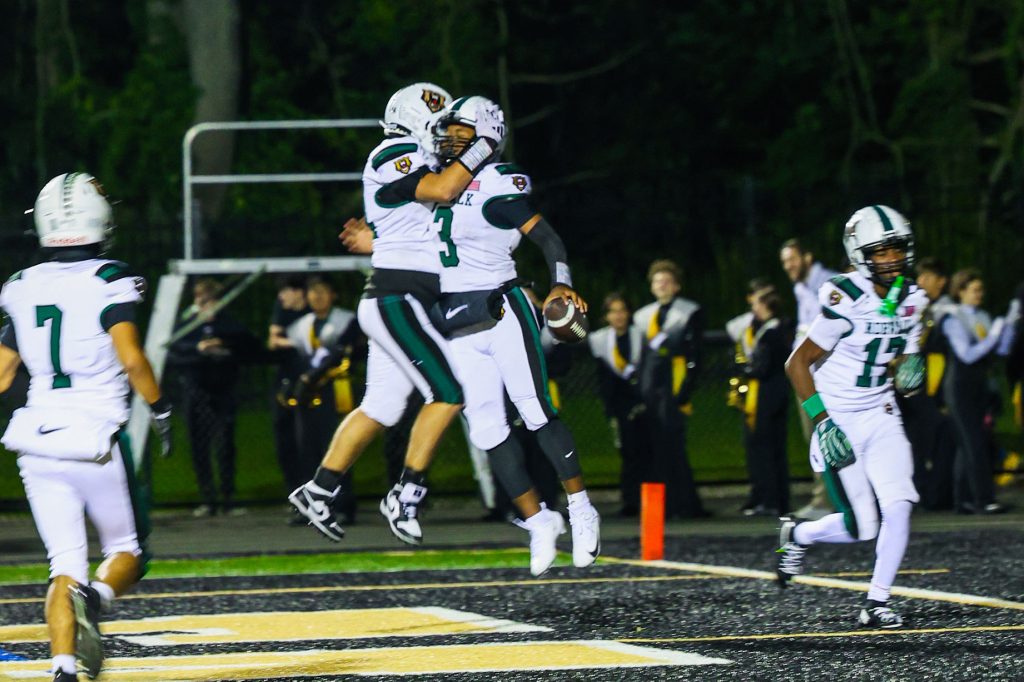 The Norwalk football team, including quarterback Easton Pace (3), celebrates a touchdown against Trumbull on Friday, Sept. 25, 2026. - Photo by Luke Sherman/Norwalk Digital Media and Communication Academy