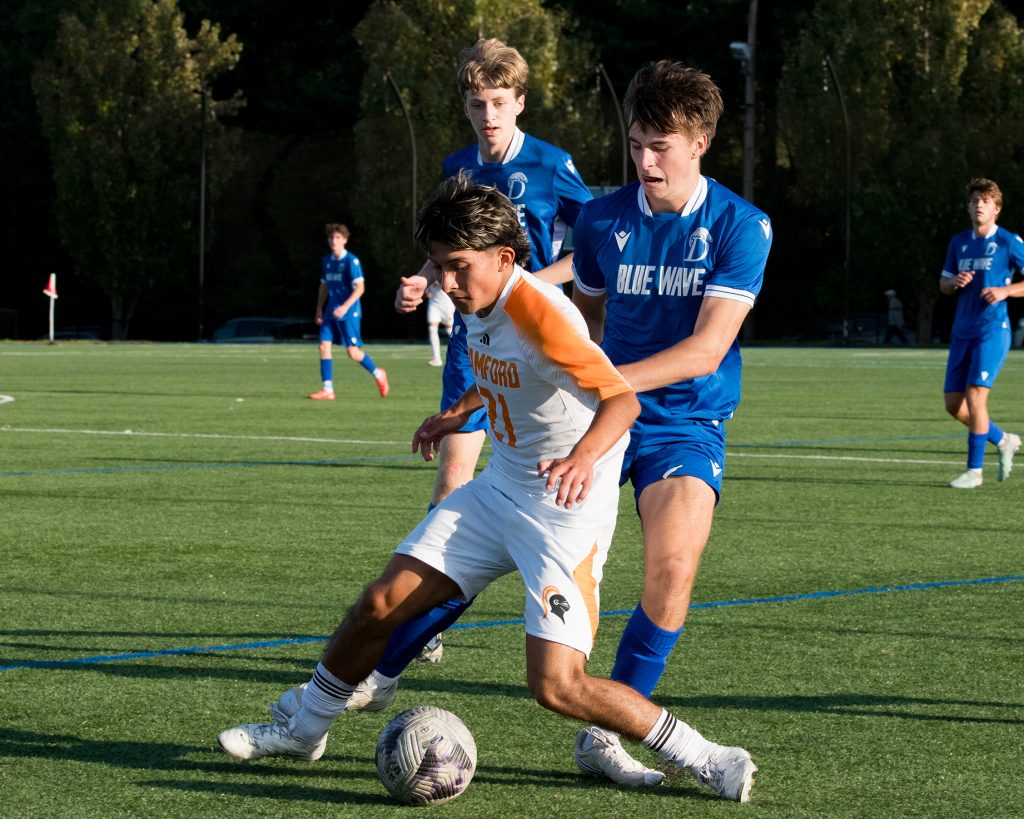 Stamford's Alexander Mejia (21) battles against Darien during a boys soccer game on Wednesday, Sept. 30, 2026. - Photo by James Barron