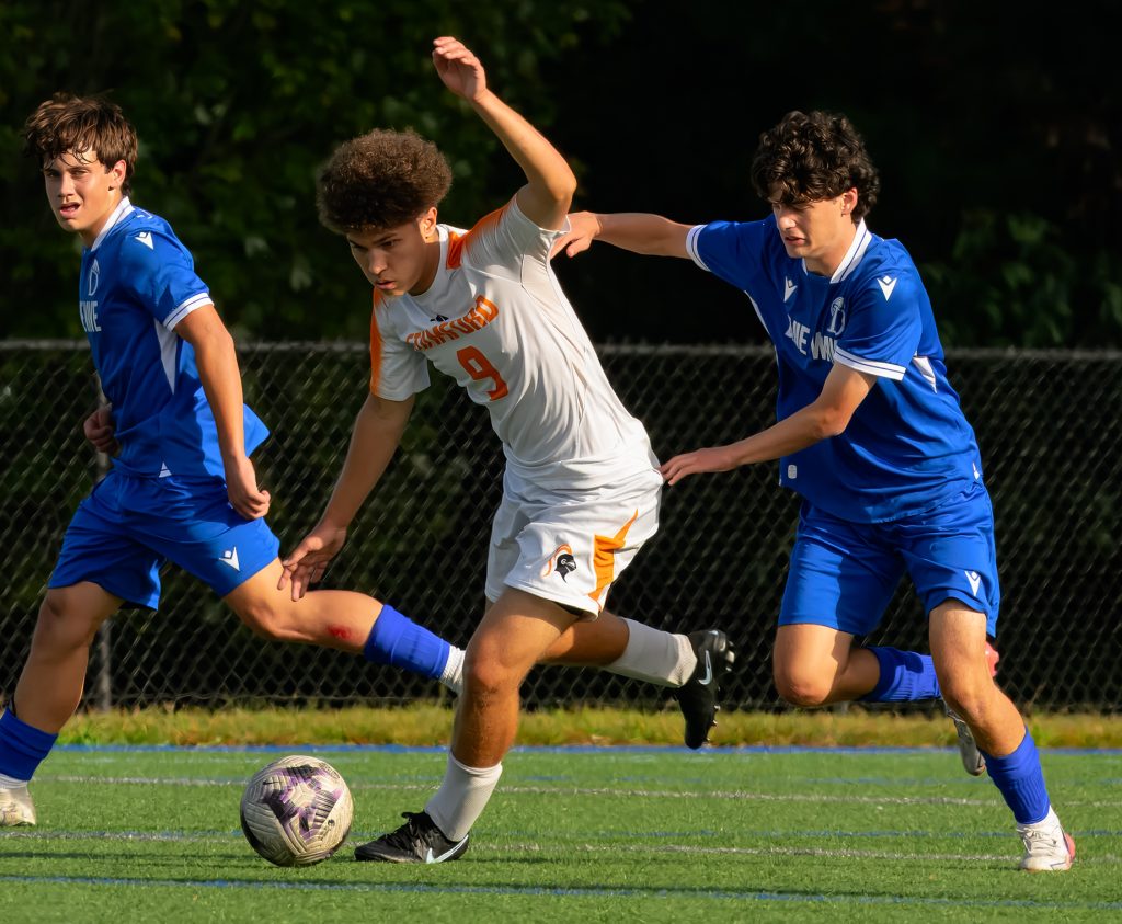 Stamford's Eric Luini (9) battles against Darien during a boys soccer game on Wednesday, Sept. 30, 2026. - Photo by James Barron